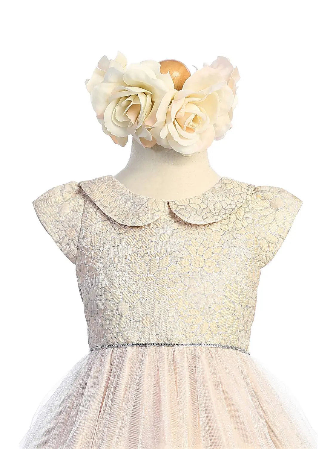 bodice details of baby special occasion formal dress that is cream and light pink