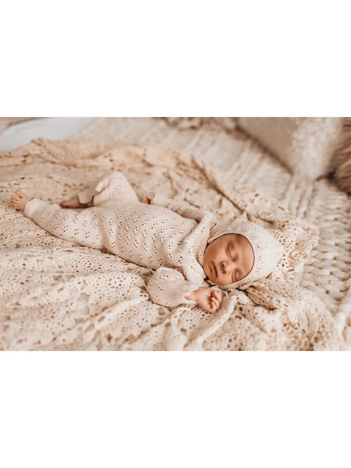 sleeping baby wearing knit outfit