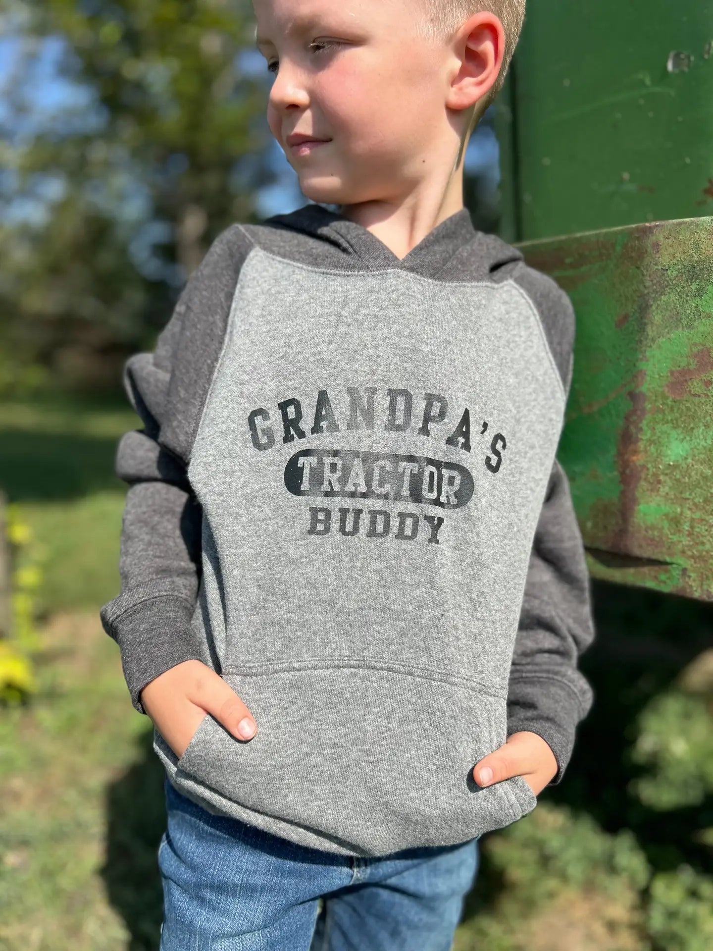 Farm kid wearing grey Tractor hoodie