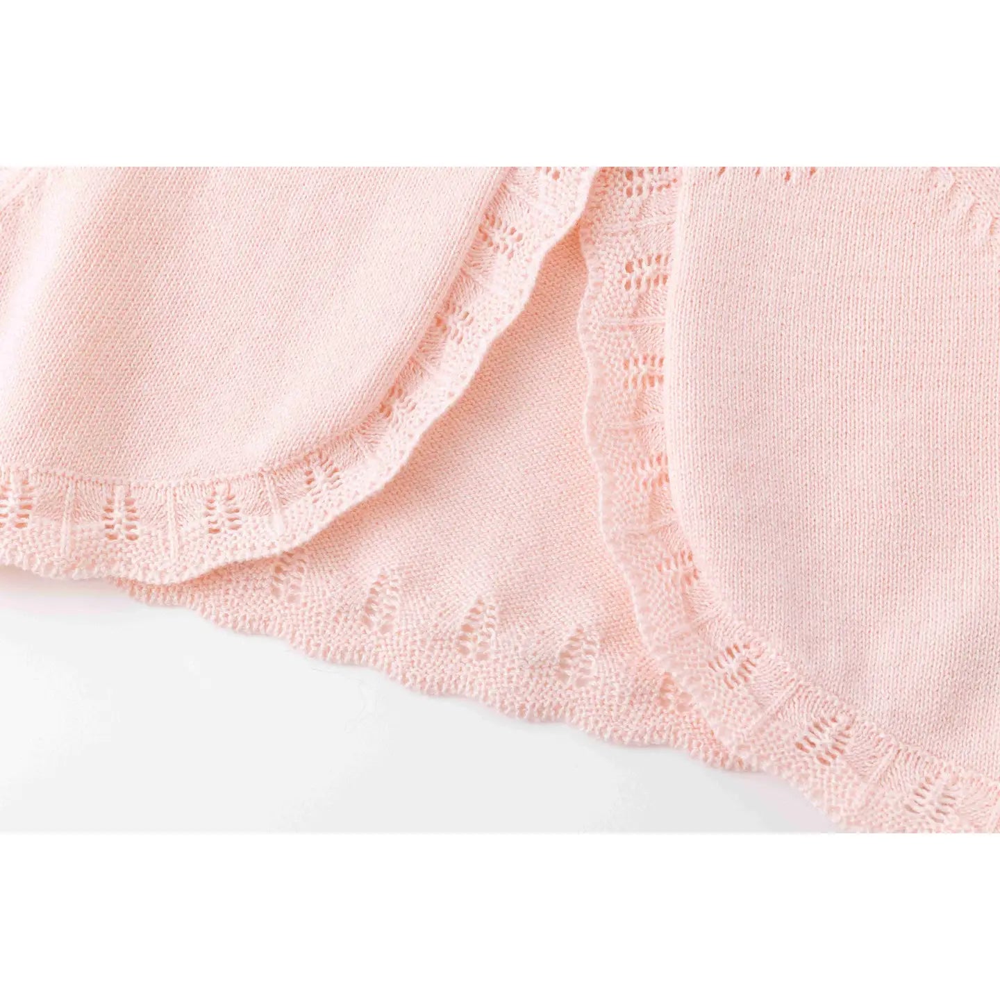 scalloped knit edges of baby sweater