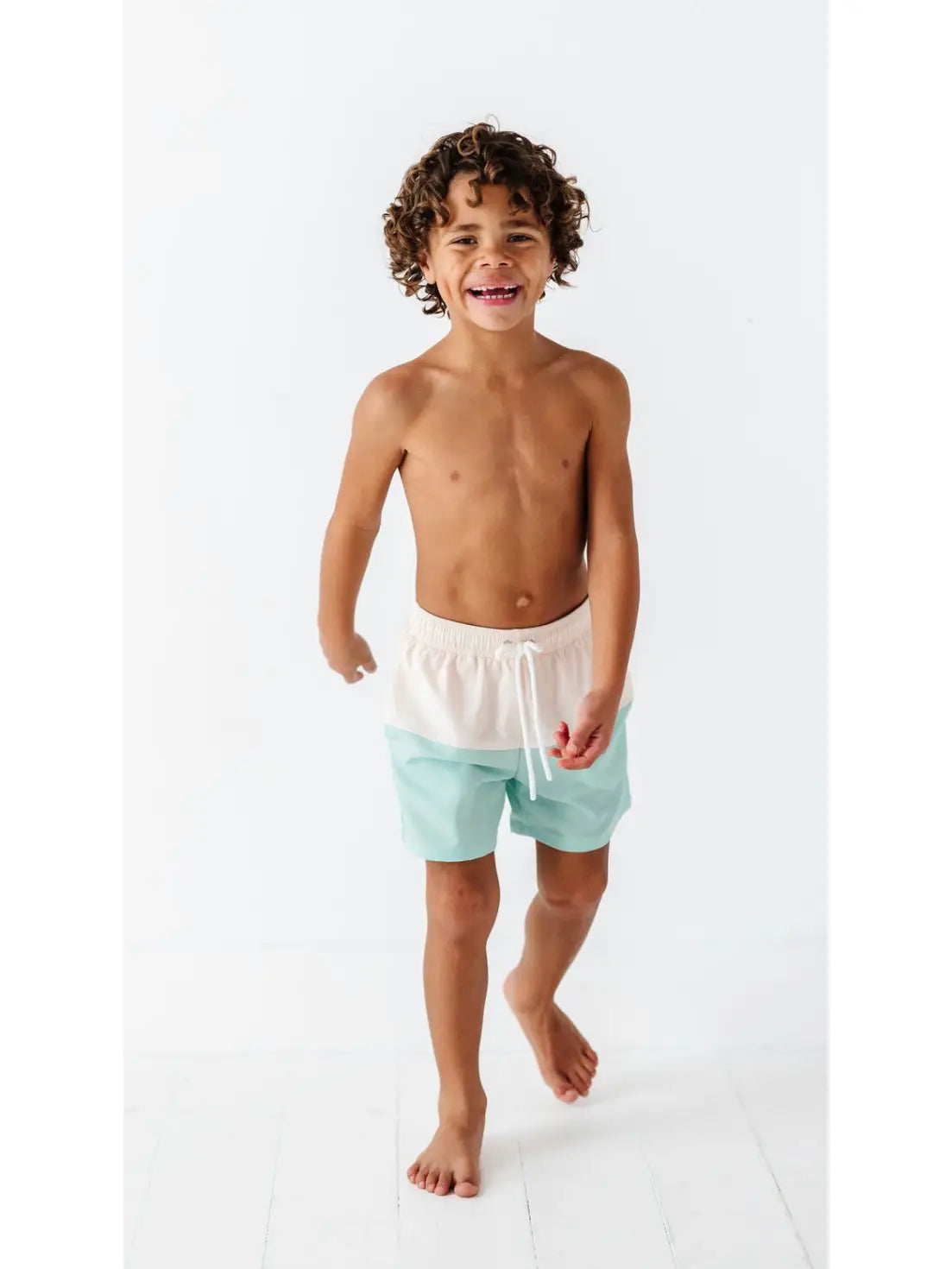 Boy wearing swim board shorts