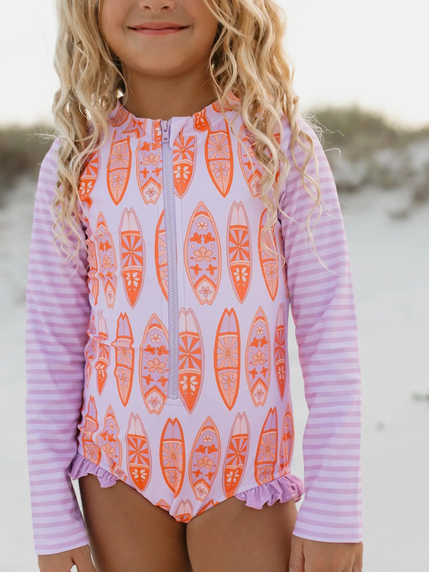 girls purple and orange long sleeve rash guard with surfboards on it