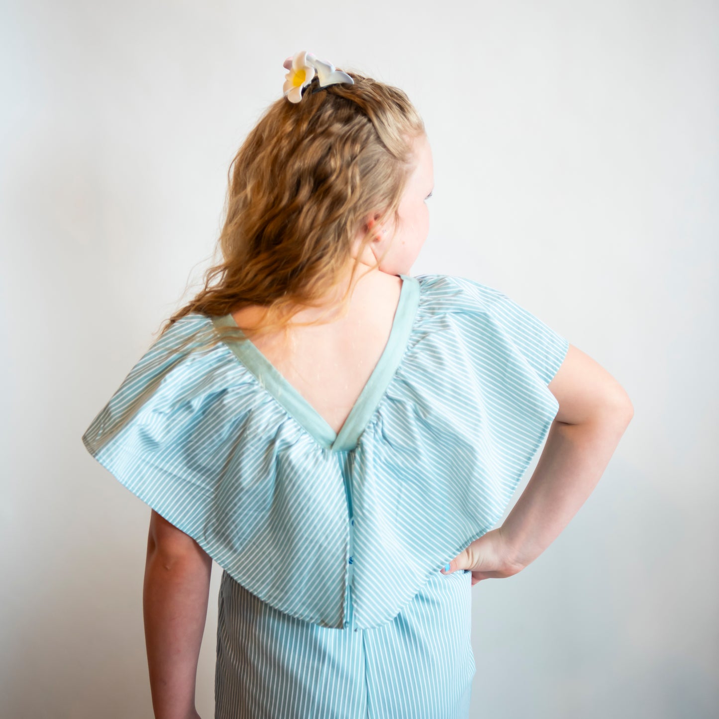 deep v back of teal pantsuit