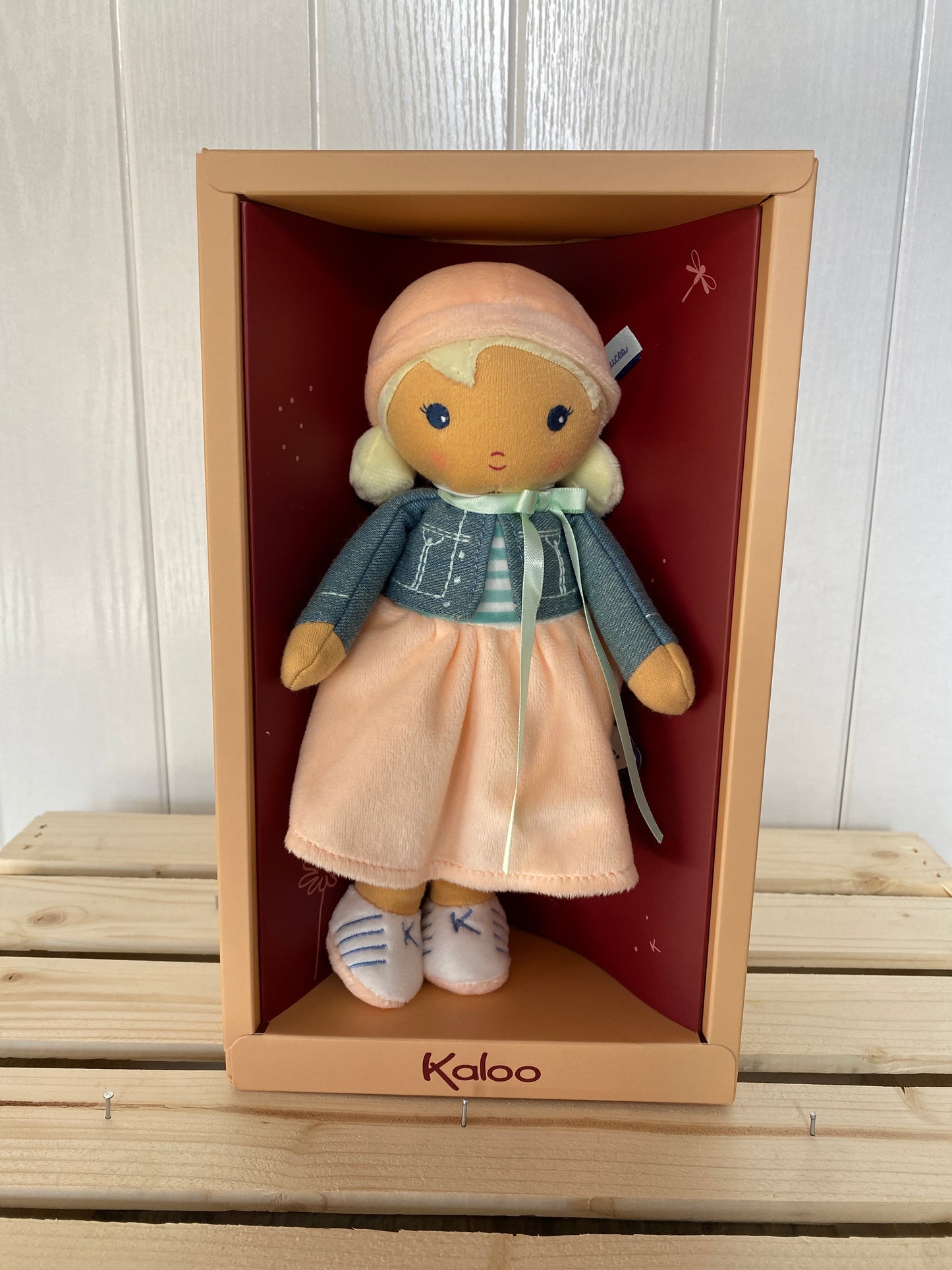 soft plush toy doll with blond hair and peach hat and skirt
