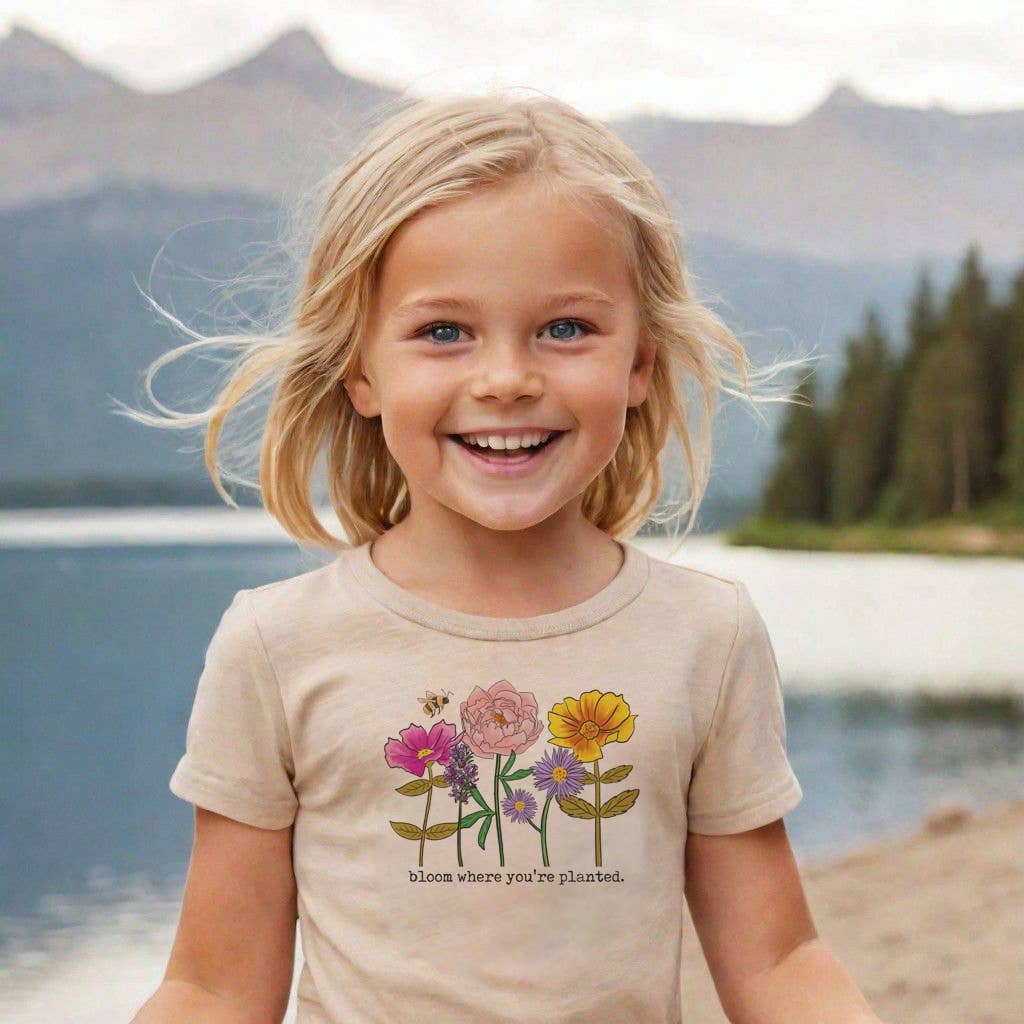 girl wearing a shirt that says bloom where you're planted