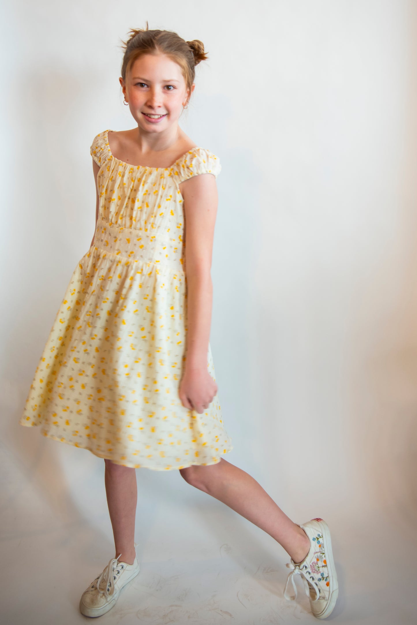 teen wearing a sundress with yellow flowers all over