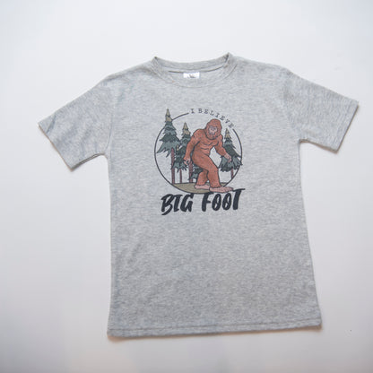 grey kids t-shirt with bigfoot graphic and words "I believe"