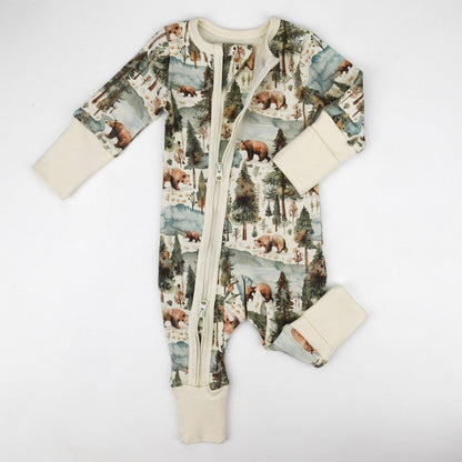 Baby onesie with bear and forest pattern on a white background