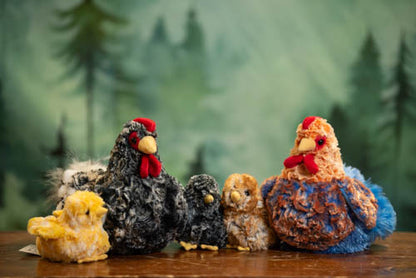 Collection of knitted chickens with a forest background