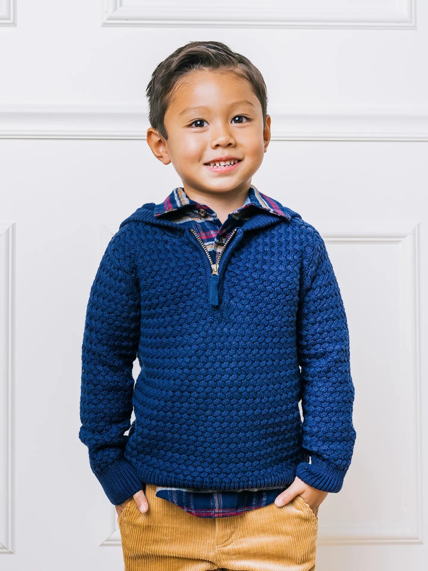 boy wearing navy blue hooded sweater with chunky knit