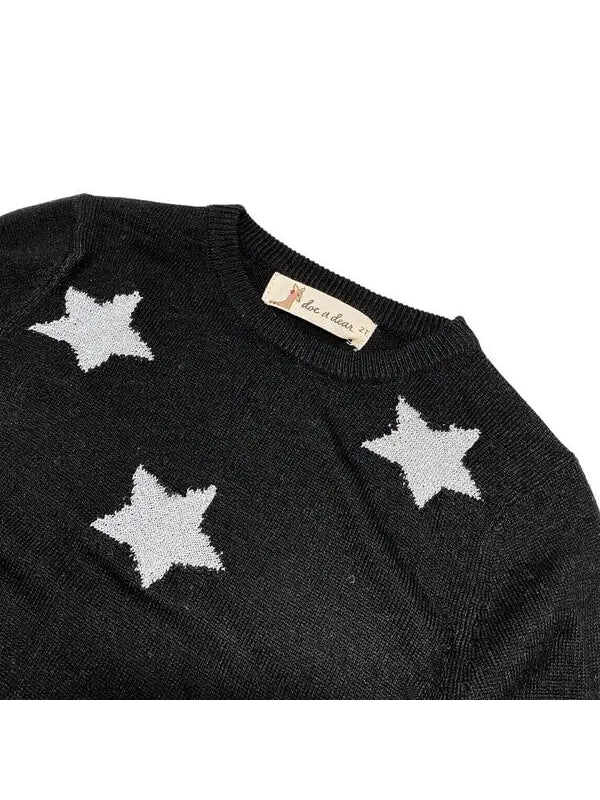 crew neckline of little girls black sweater with silver stars on it.