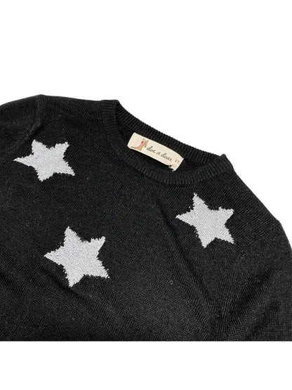 crew neckline of little girls black sweater with silver stars on it.