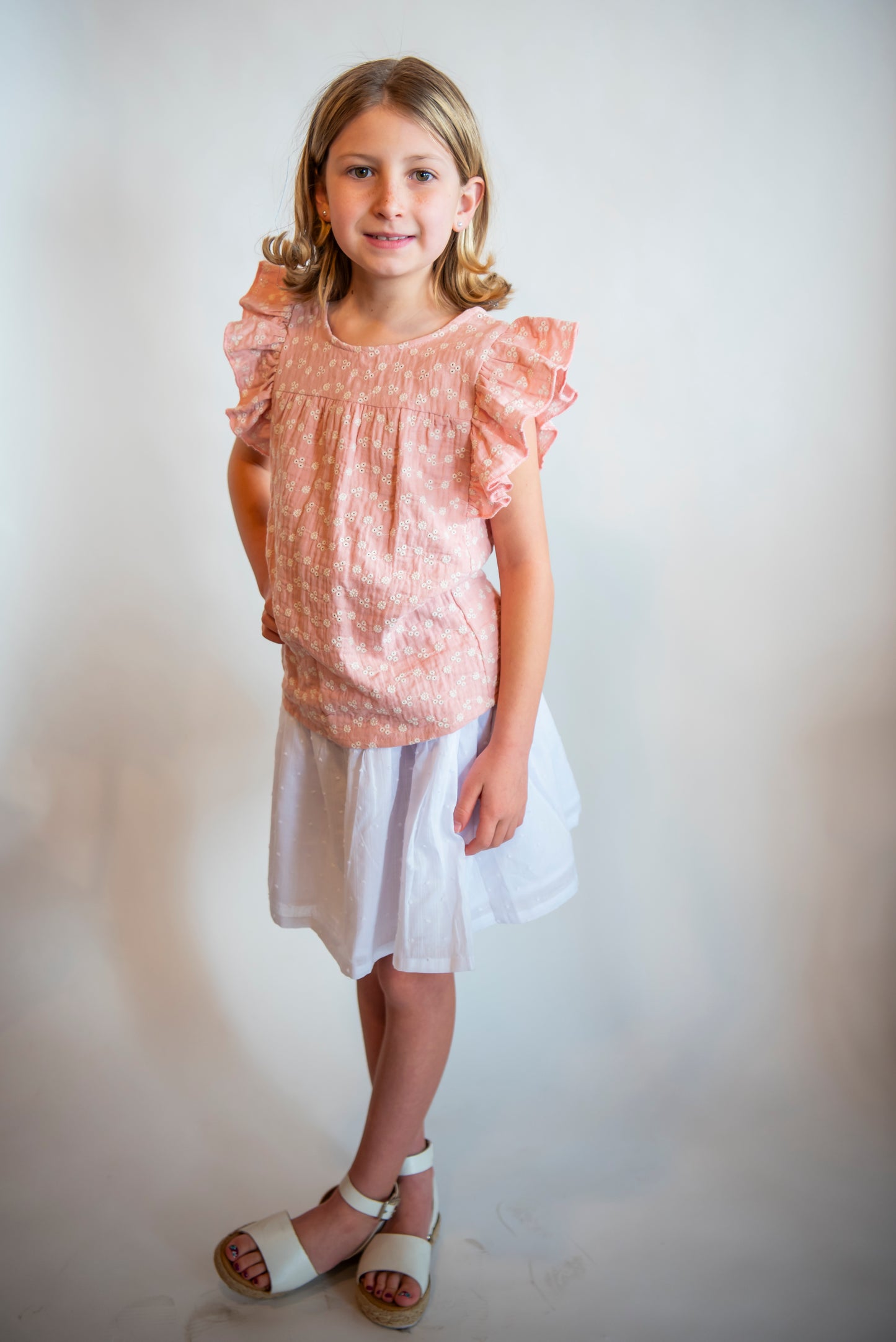 tween wearing cute cotton pink shirt with white cotton skirt and sandals