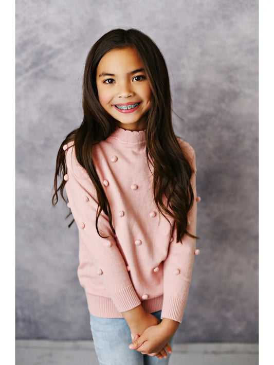 girls pink pullover sweater with pom pom details