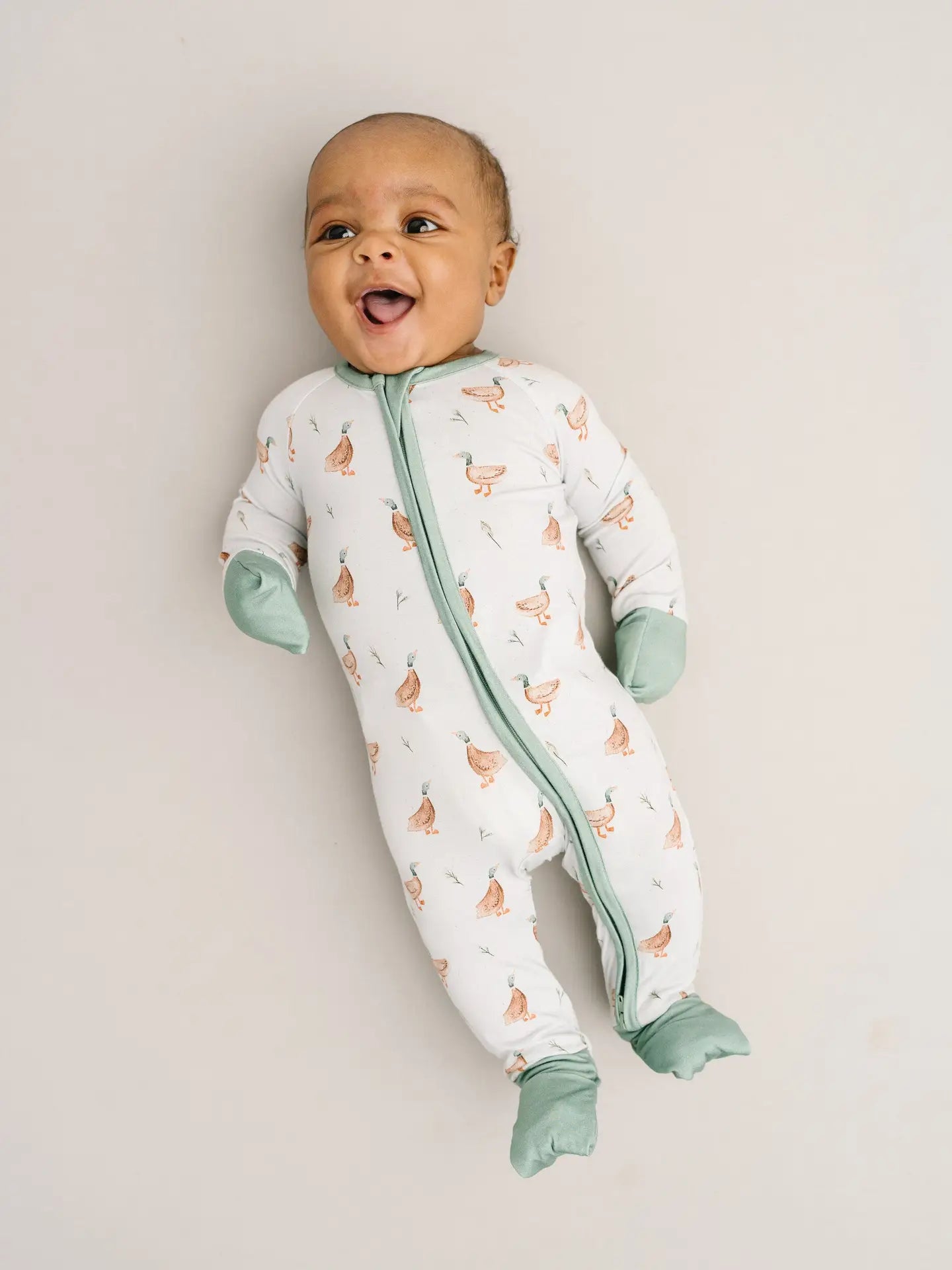 baby wearing soft green bamboo pajamas with ducks 