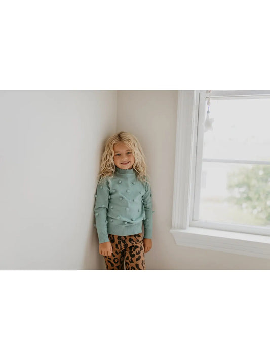 girls pullover sweater with pom-poms stitched on