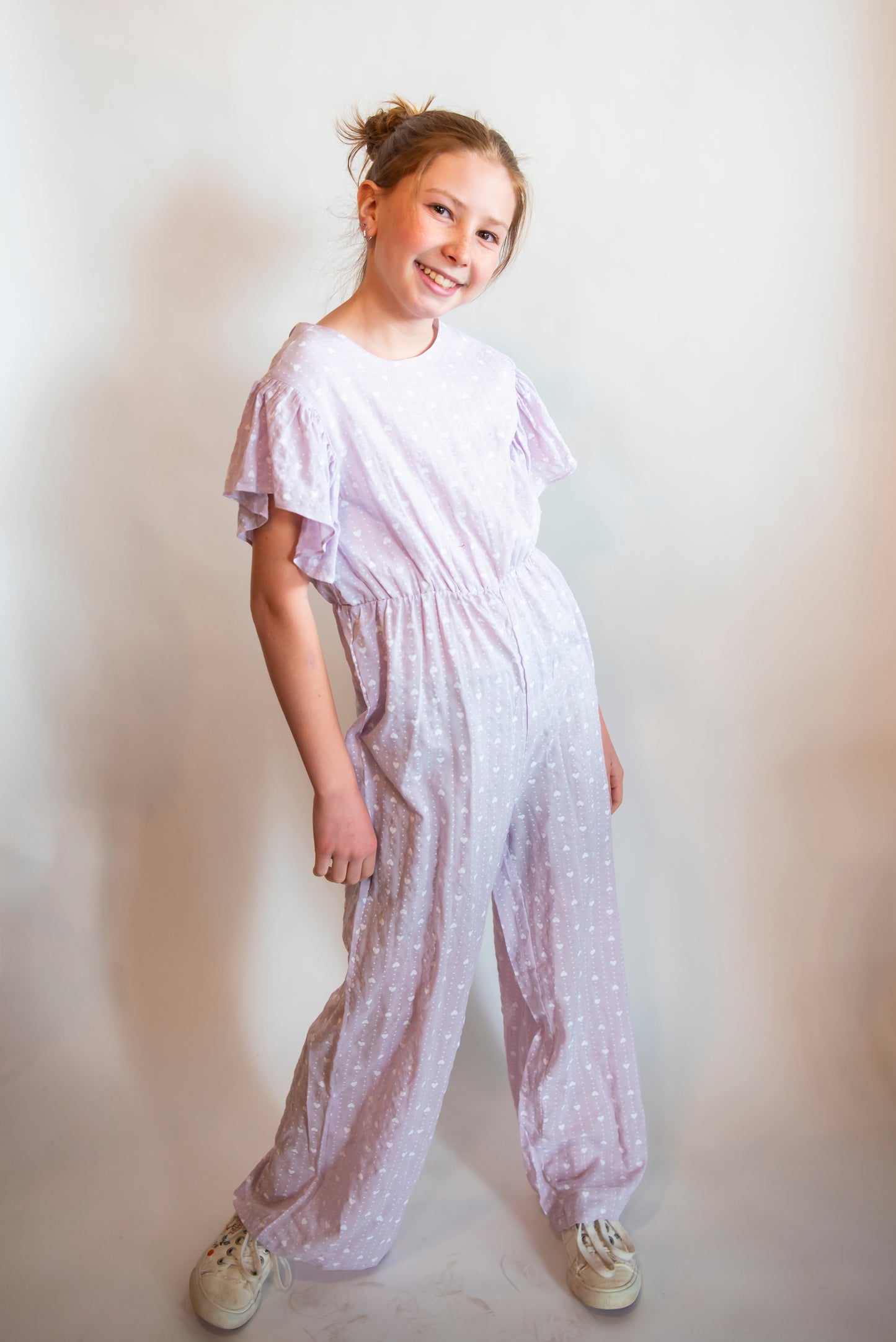 tween wearing a purple cotton pantsuit or jumpsuit