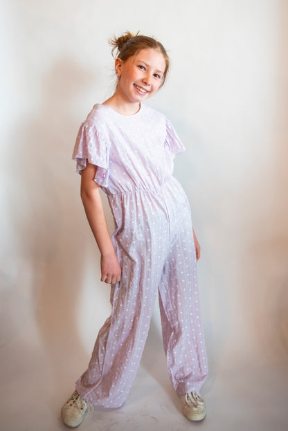 tween wearing a purple cotton pantsuit or jumpsuit