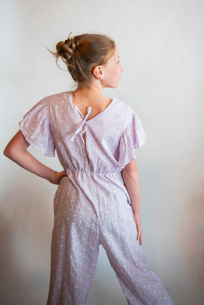 back of tween jumpsuit with ruffle sleeves and tie closure
