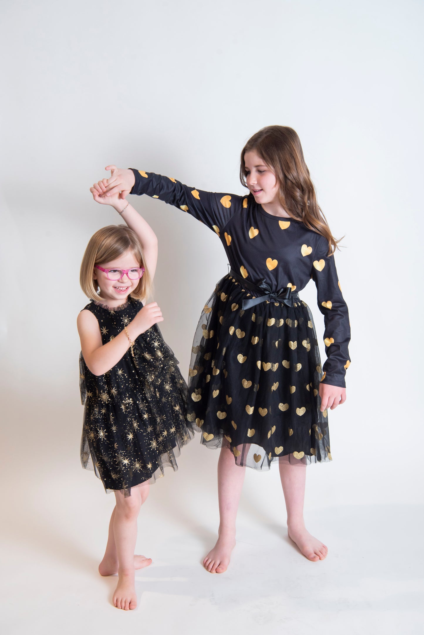 girls long sleeve black and gold dress with tulle and glitter hearts