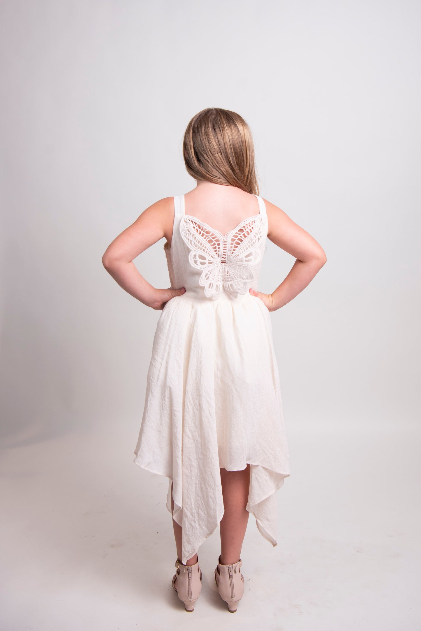 tween girl back of cream dress with butterfly lace detail