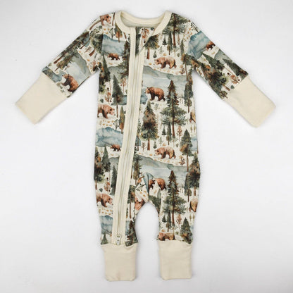 Baby onesie with forest and bear pattern on a white background