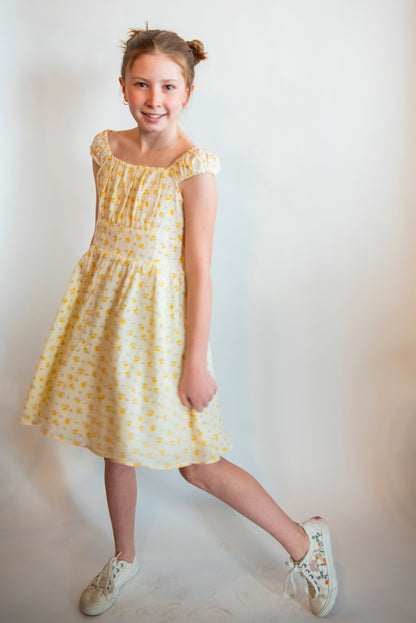 teen wearing a sundress with yellow flowers all over
