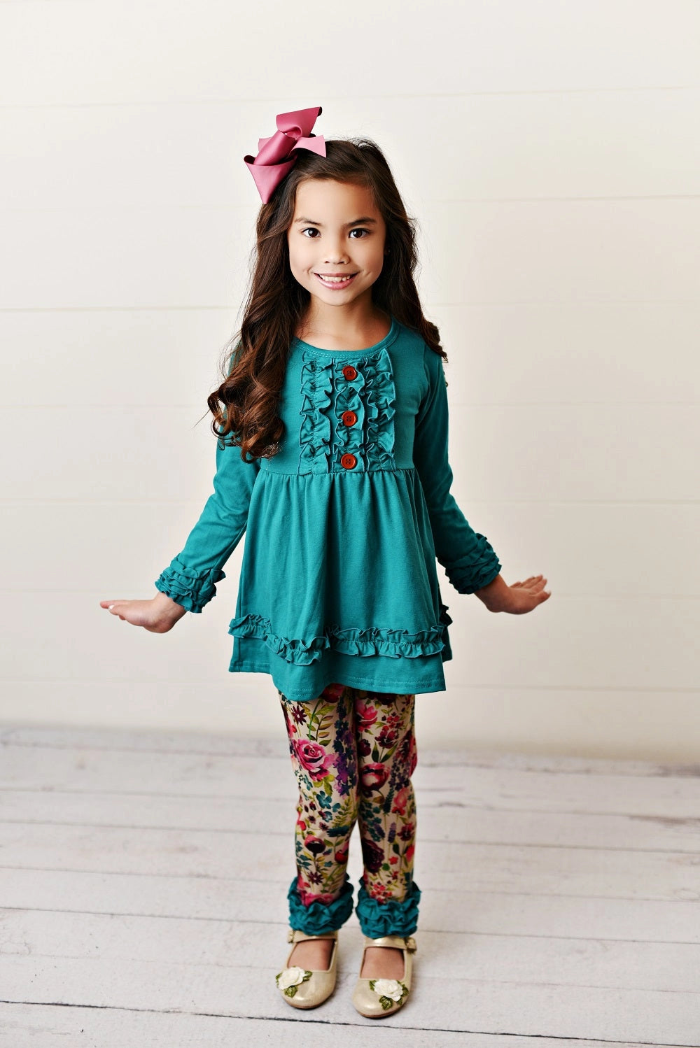 girls outfit with teal long sleeve ruffle tunic top and floral leggings with ruffle cuffs